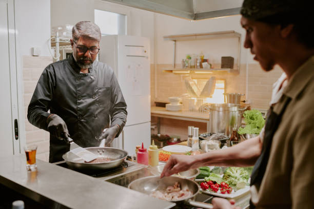 istock Professional Chef Frying Steak 2163829195