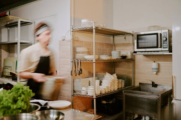 istock Young Cook Going with Huge Pot in Hand 2163829429