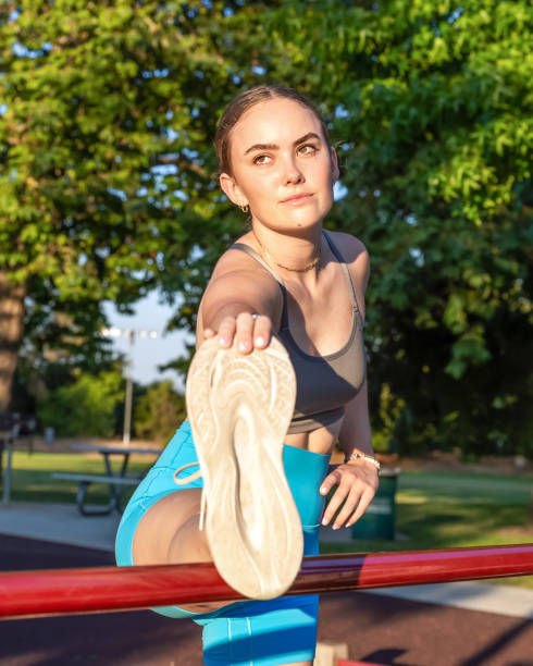 istock Young woman stretching hamstring on bar 2163831148