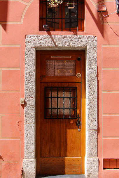 istock Rustic Wooden Door with Stone Frame on Terracotta Wall 2163832377
