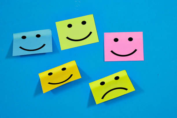 istock Testimonial rating concept with emotion faces on colorful sticky notes on blue background. happy and sad faces drew on sticky notes 2163834658