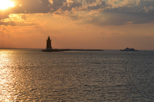 istock Delaware Breakwater Lighthouse at Cape Henlopen State Park at sunset with Cape May - Lewes Ferry 2163836596