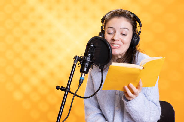 istock Upbeat professional voice actor recording audiobook, studio background 2163842167