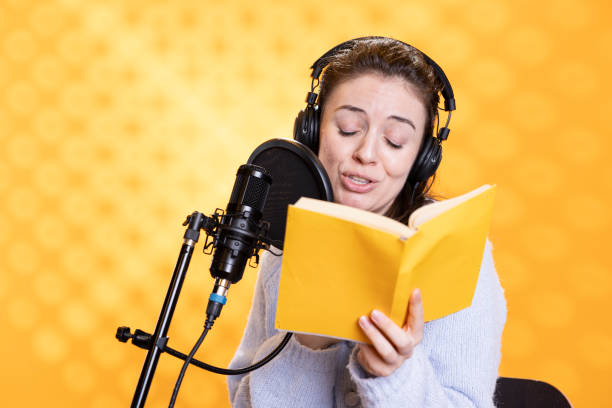 istock Voice actor recording audiobook, playing character, studio background 2163842311