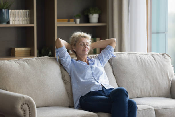 istock Silent peaceful middle-aged woman relaxing on sofa, take daytime break 2163843337