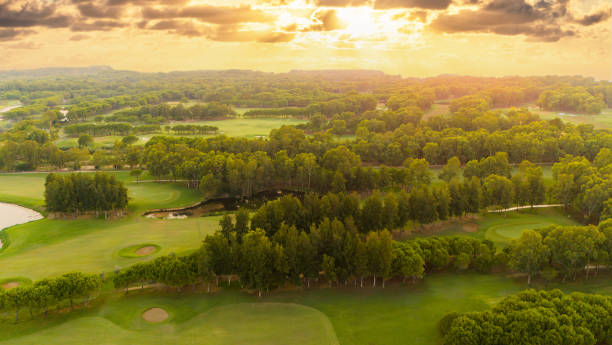 istock Golf course at sunset. Scenic panoramic aerial view of golf course at sunset with beautiful sky. Drone view 2163845708