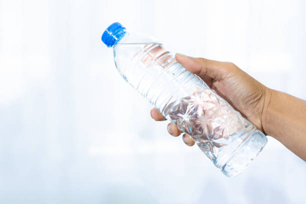 istock Drinking water bottle and human hands isolated on white background,Man holding a bottle of water isolated on white background 2163845922