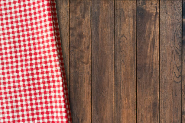 istock Top view of red gingham checkered table cloth on old wooden table background. Picnic napkin kitchen backdrop. 2163846310