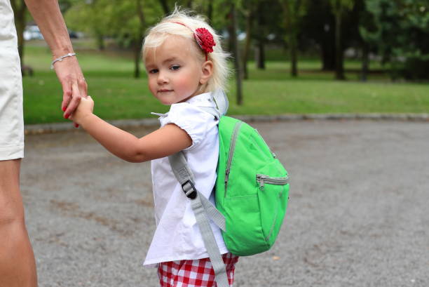 istock Little girl with backpack going to school, study concept 2163847582