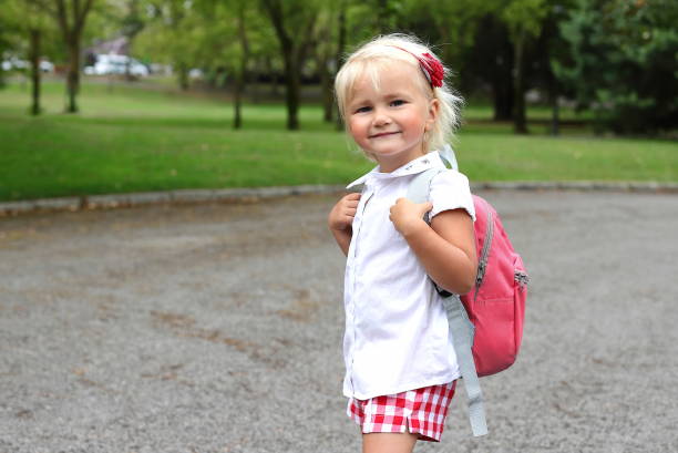 istock Little girl with backpack going to school, study concept 2163847592