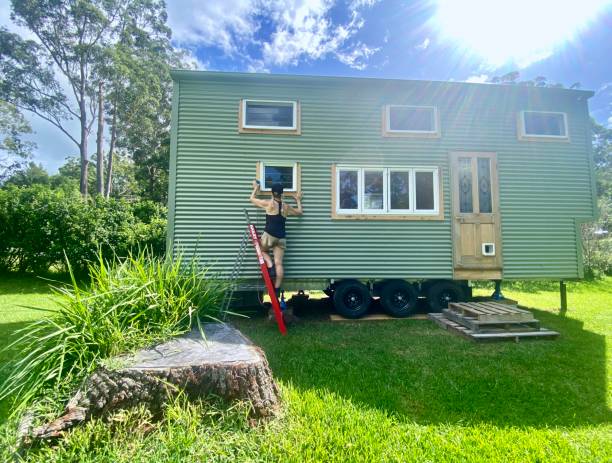 Woman Working on Tiny House DIY Build stock photo
