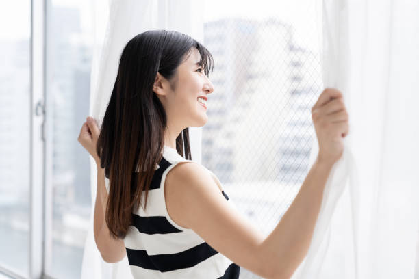 istock asian woman , Open the curtains 2163856531