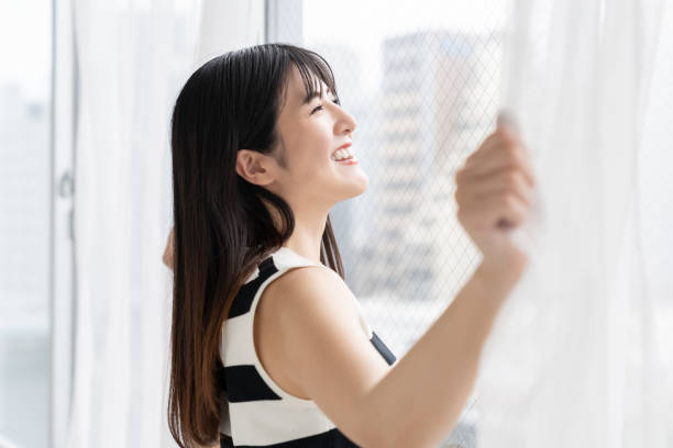 istock asian woman , Open the curtains 2163856534