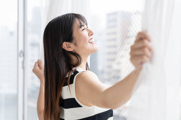 istock asian woman , Open the curtains 2163856552