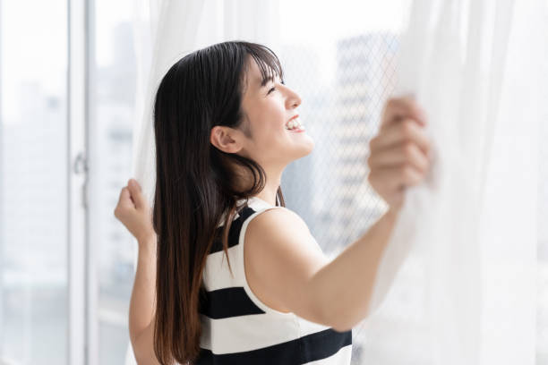 istock asian woman , Open the curtains 2163856584