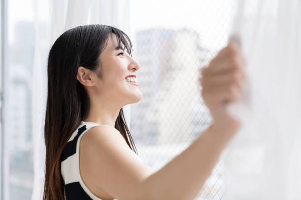istock asian woman , Open the curtains 2163856590