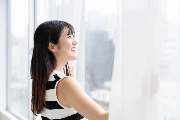 istock asian woman , Open the curtains 2163856591