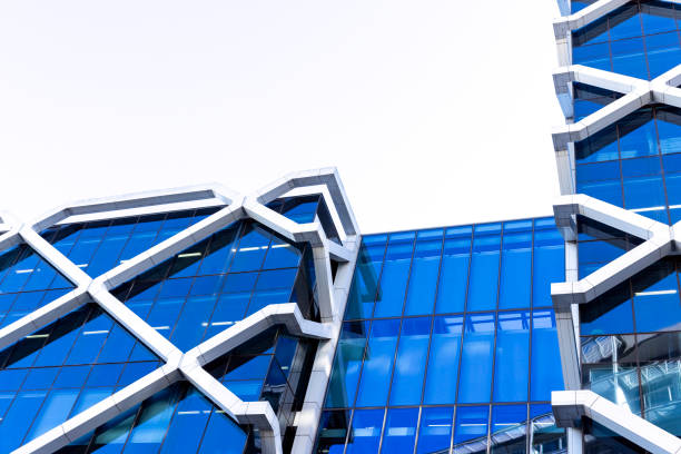 Closeup low angle view of modern corporate glass building, Barangaroo Sydney, background with copy space, full frame horizontal composition
