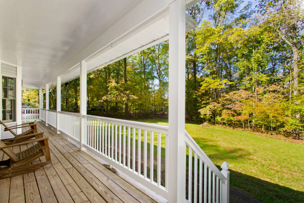 istock Charming Front Porch With White Railings Overlooking Lush Green Grass. 2163860724