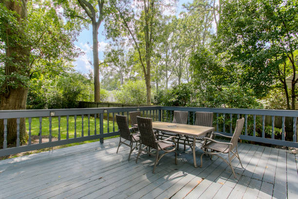 istock Outdoor Deck Area With Table And Chairs Surrounded By Trees On A Sunny Day. 2163860743