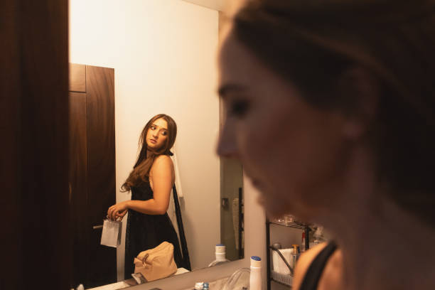 istock Mother helps her daughter get dressed before the prom party 2163863664