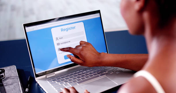 istock Woman's Hand Filing Online Registration Form On Laptop 2163868004