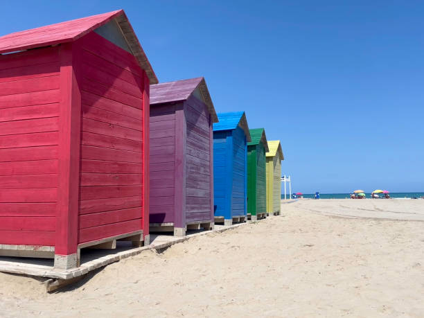istock Brightly coloured beach huts on Spanish beach 2163873700