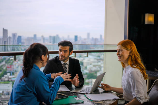 istock White collar worker meeting at high rise tower. 2163875546