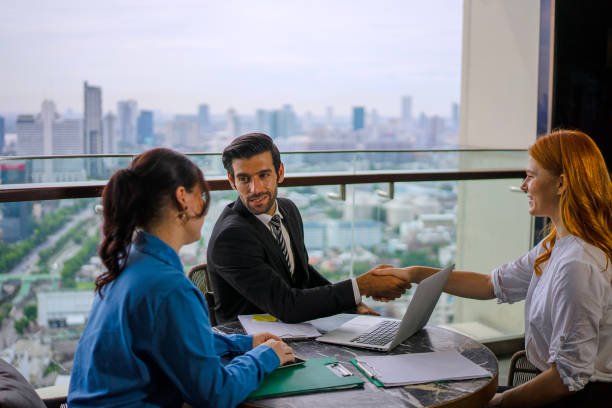 istock White collar worker meeting at high rise tower. 2163875549