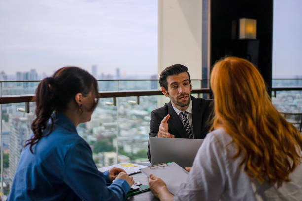 istock White collar worker meeting at high rise tower. 2163875587