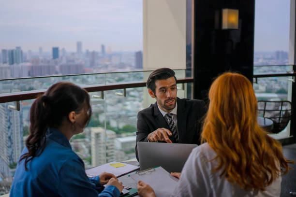 istock White collar worker meeting at high rise tower. 2163875588