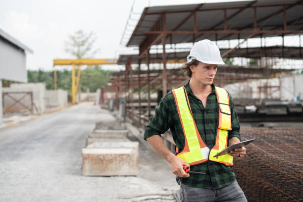 istock Happy Portrait caucasian engineer man use tablet computer working at precast cement outdoor factory 2163877948