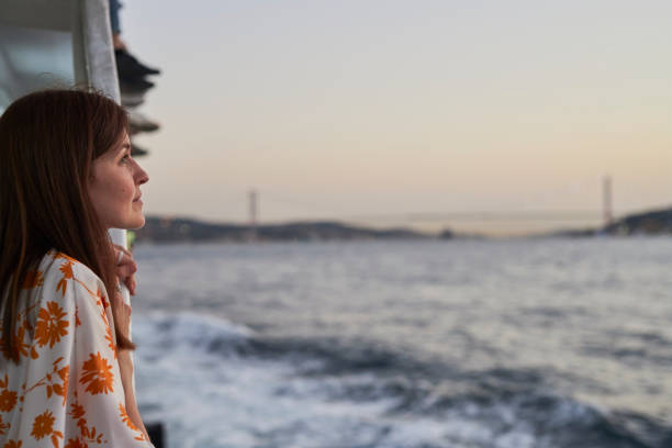 istock Beautiful lady enjoying bosphorus tour istanbul 2163879518