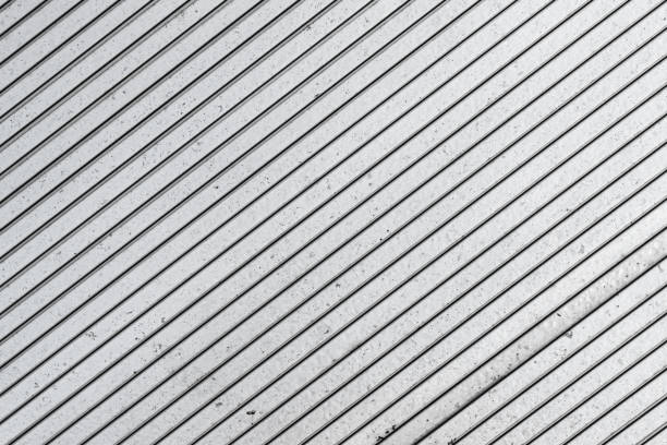 istock Parallel stripes pattern. Evenly spaced gray lines. Grainy, grunge, and industrial texture. 2163880551