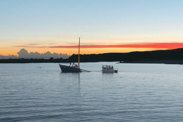 a sunken ship in the pacific ocean at sunset