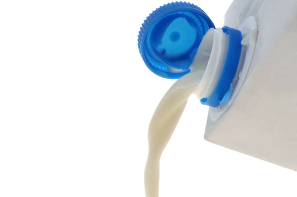istock Pouring milk closeup on white background 2163886357