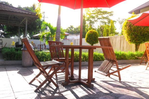 istock folding table chairs from the garden with green grass and afternoon sunlight. cafe table chairs set by the swimming pool 2163887107