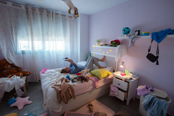 istock Lazy teenager using digital tablet in her messy bedroom 2163887500