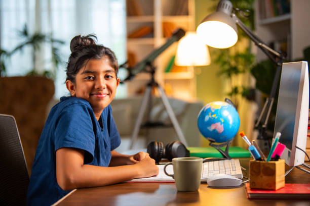 istock Indian asian small girl studying at home on computer desk 2163888955