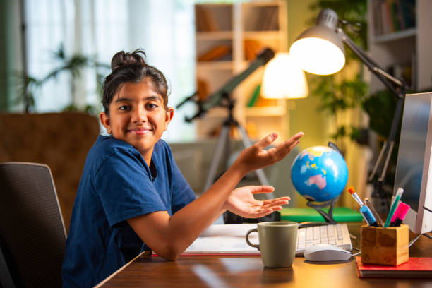 istock Indian asian small girl studying at home on computer desk 2163888956