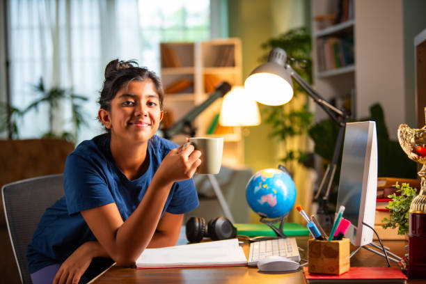 istock Indian asian small girl studying at home on computer desk 2163888957