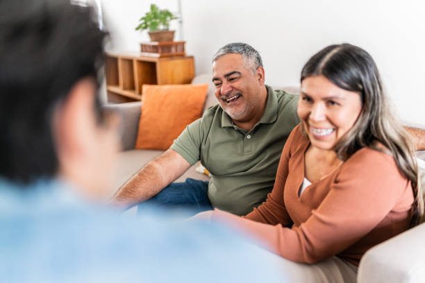 istock Happy family talking at home 2163890052