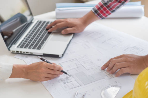 istock Architects interior designer hands working with Blue prints and documents for a home renovationÂ for house design 2163890067