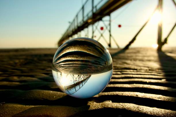 istock Crystal ball on the beach with pier background 2163892988