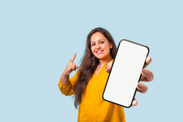 istock Indian asian young woman showing big smartphone with empty screen 2163894613