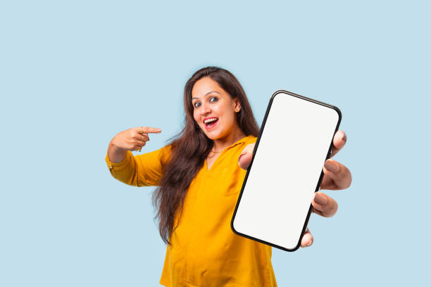 istock Indian asian young woman showing big smartphone with empty screen 2163894622