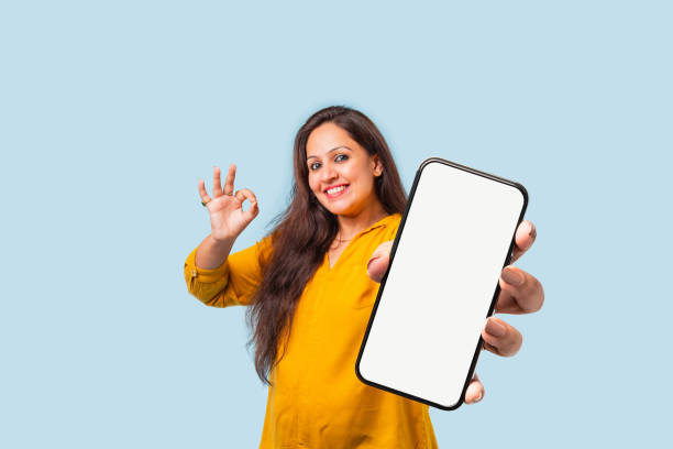 istock Indian asian young woman showing big smartphone with empty screen 2163894637