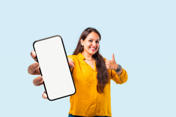 istock Indian asian young woman showing big smartphone with empty screen 2163894644