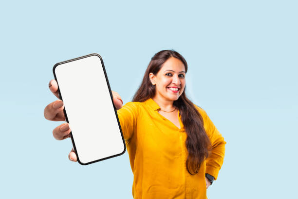 Indian asian young woman showing big smartphone with empty screen