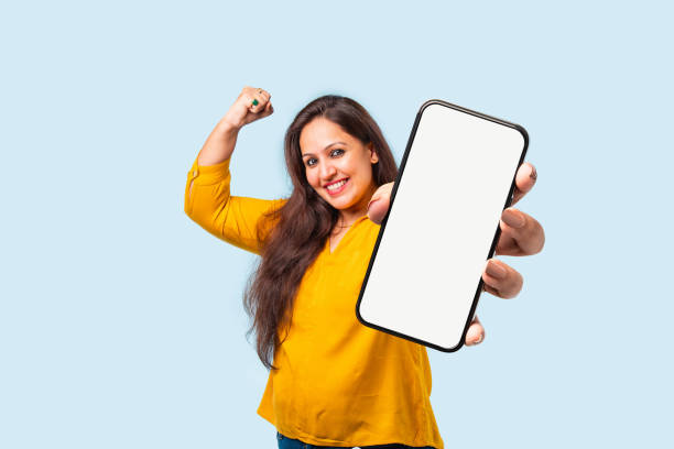 istock Indian asian young woman showing big smartphone with empty screen 2163894663